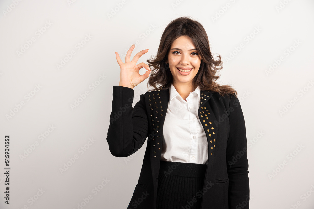 Positive woman showing ok sign on white background Positive woman showing ok sign on white background