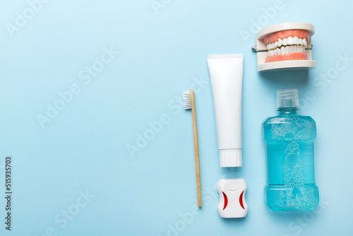 Mouthwash and other oral hygiene products on colored table top view with copy space. Flat lay. Dental hygiene. Oral care kit. Dentist concept