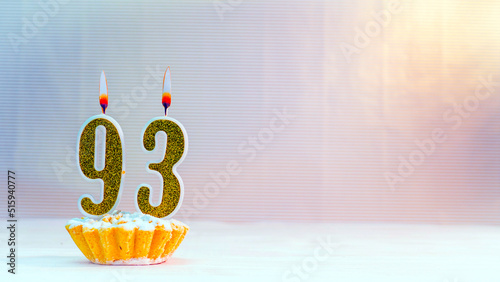 Happy birthday card from candles with the number 93, golden numbers from candles for congratulations on any holiday.