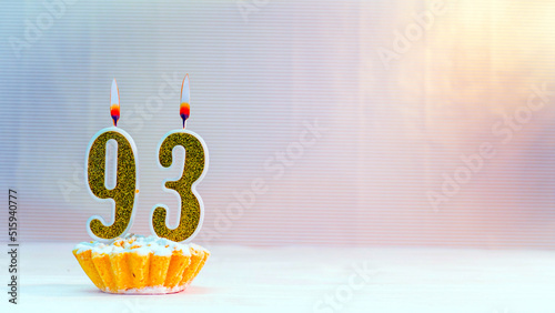 Happy birthday card from candles with the number  93, golden numbers from candles for congratulations on any holiday. photo