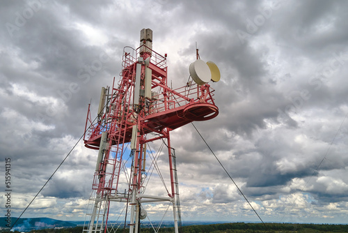 Aerial view of telecommunications cell phone tower with wireless communication antennas for network signal transmission