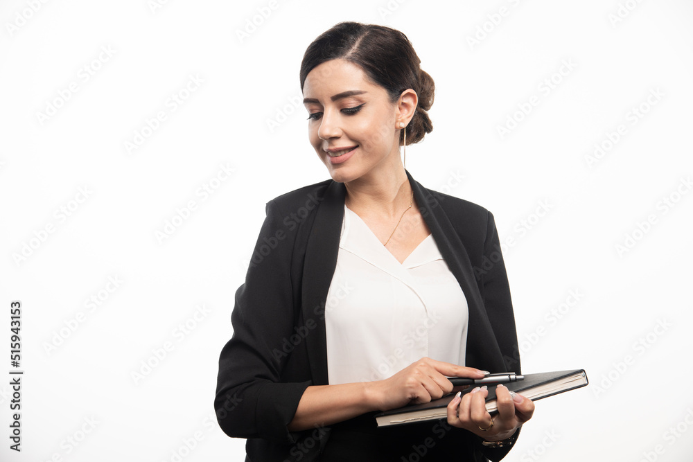 Smiling woman posing with notebook on white background Smiling woman posing with notebook on white background