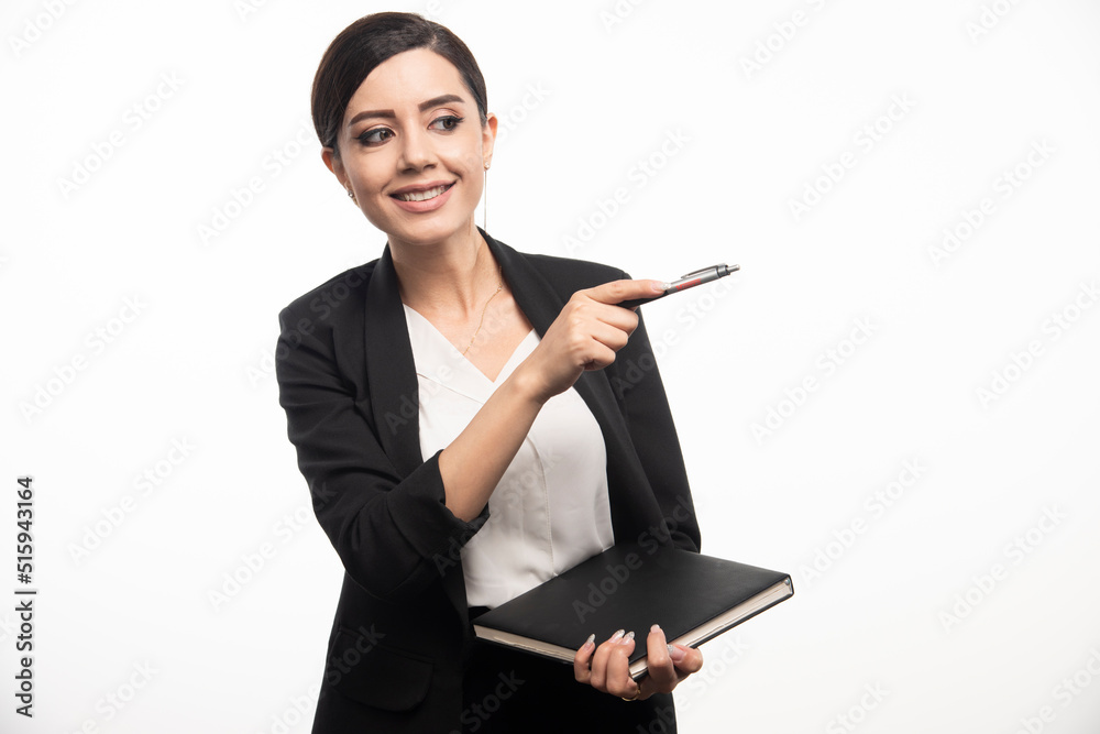 Happy woman posing with notebook on white background Happy woman posing with notebook on white background