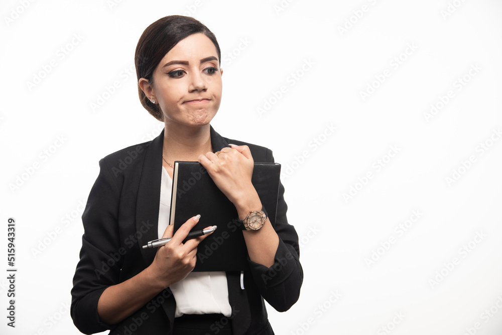 Young woman posing with notebook on white background Young woman posing with notebook on white background