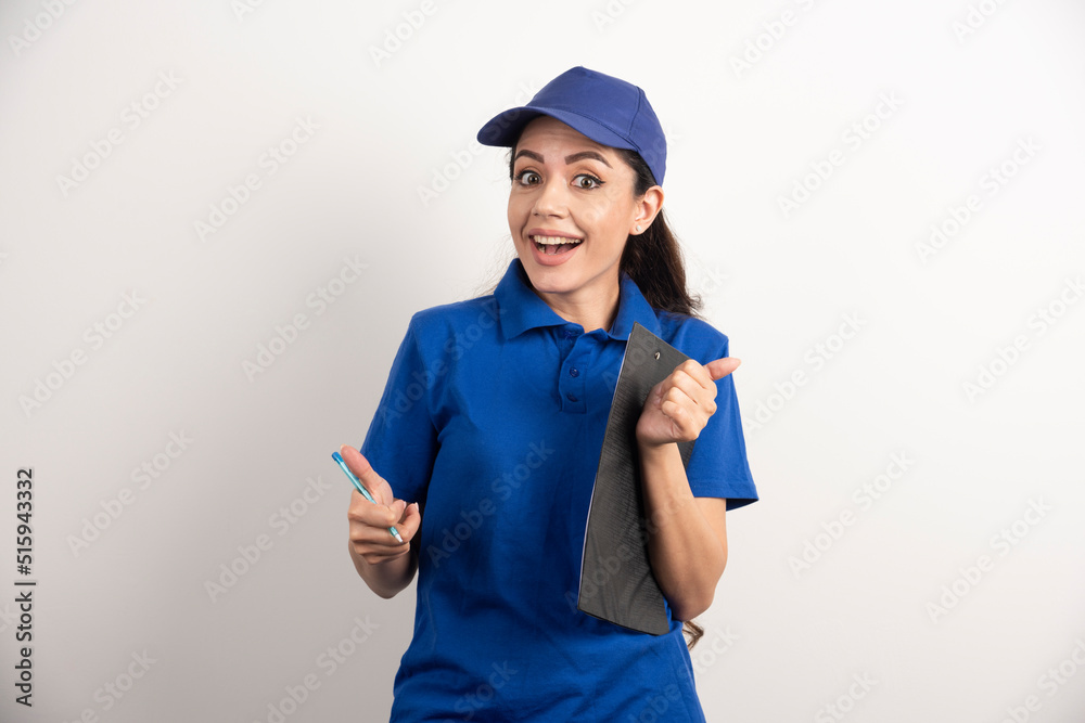 Portrait of young delivery woman with clipboard