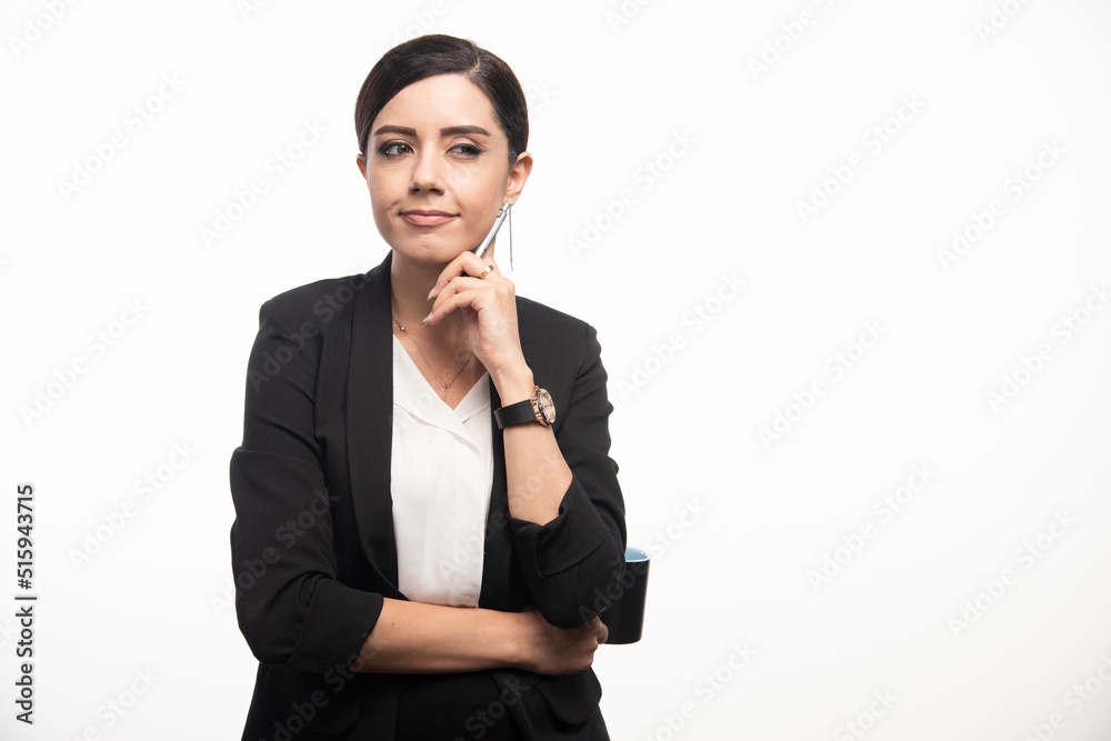 Businesswoman with cup and a pencil on a white background Businesswoman with cup and a pencil on a white background