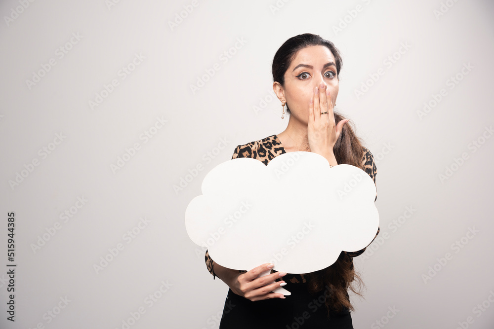 Businesswoman in leopard printed shirt holding a cloud shape ideaboard Businesswoman in leopard printed shirt holding a cloud shape ideaboard