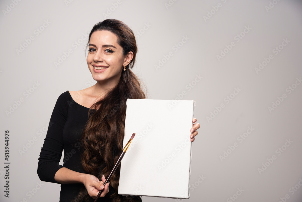 Young artist girl showing her artwork to the public and explaining ...
