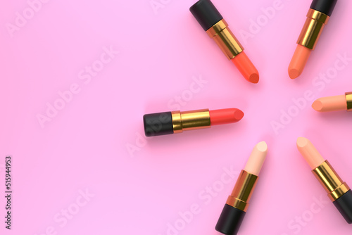 Lipsticks close-up on a pastel pink background with copy space. Women's cosmetics for professional makeup. Beauty concept. Top view. 3d rendering illustration
