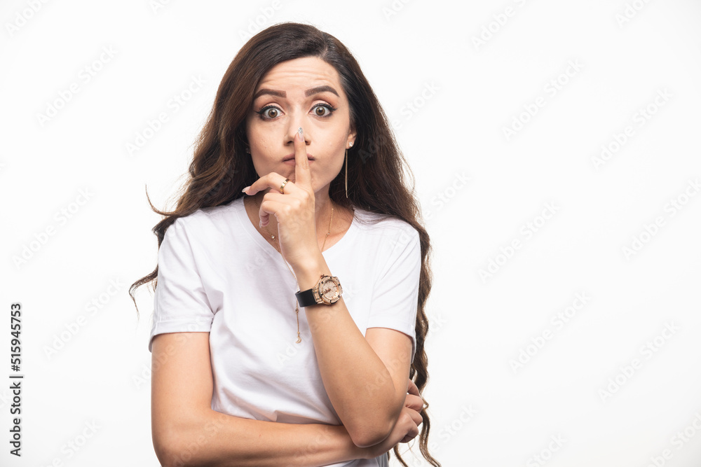 Attractive woman in white shirt touching her nose Attractive woman in white shirt touching her nose