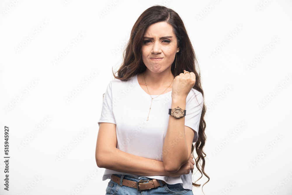 Long haired woman in white shirt posing on white background Long haired woman in white shirt posing on white background