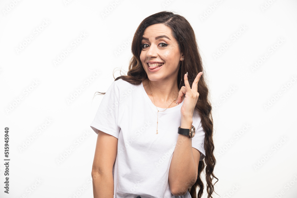 Positive woman in white shirt sticking her tongue out Positive woman in white shirt sticking her tongue out