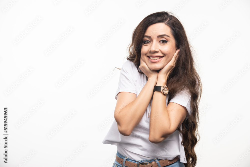 Positive woman in white shirt posing on white background Positive woman in white shirt posing on white background