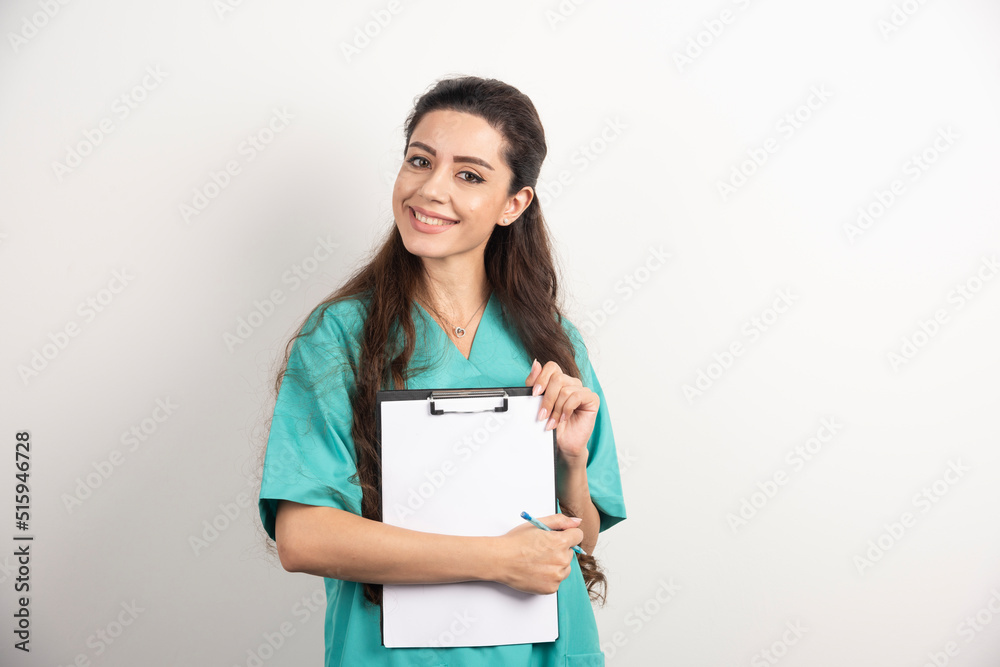Young female medical employee holding medical records Young female medical employee holding medical records