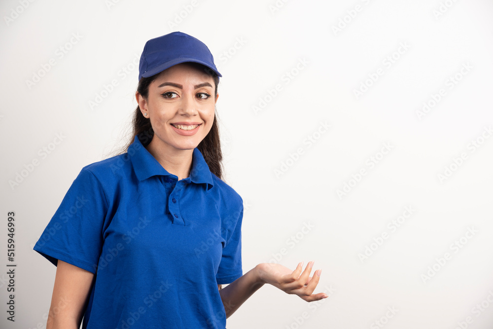 Pretty woman in blue uniform touch her face with hand Pretty woman in blue uniform touch her face with hand
