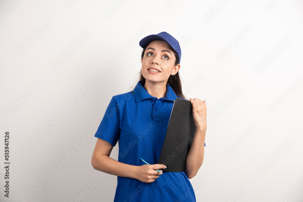 Young female courier in blue scrubs holding a clipboard Young female courier in blue scrubs holding a clipboard