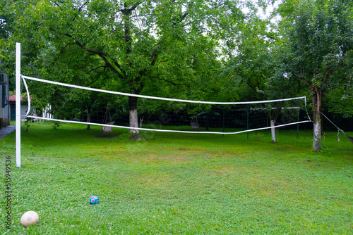 The concept idea of the volleyball net, summer housekeepers who spend pleasant moments thanks to the volleyball net in the garden of the detached house