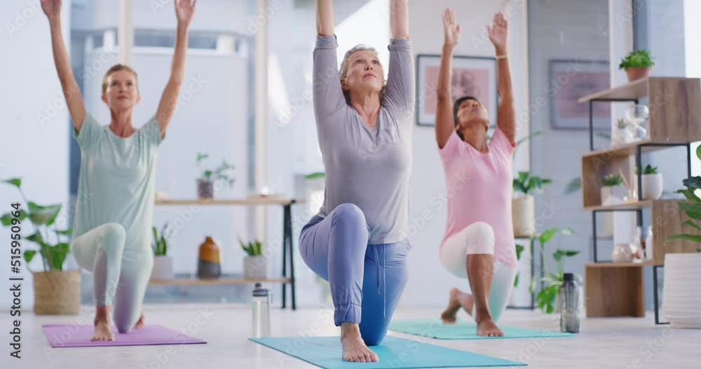 Active mature women meditating during a fitness class in a yoga studio. Yogi training a group of calm, relaxed and focused ladies. Practicing mindful exercises for a peaceful and healthy lifestyle