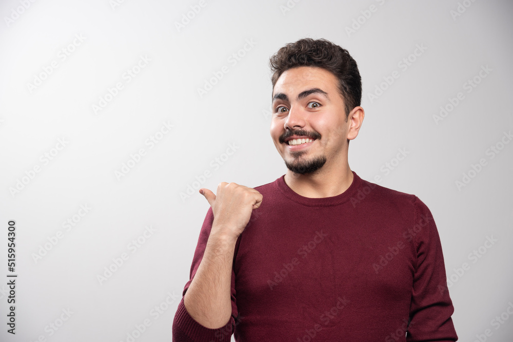 A happy brunette man showing a finger up and posing A happy brunette man showing a finger up and posing