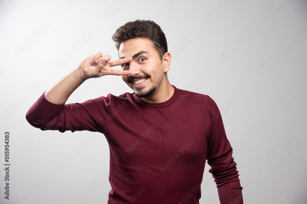 A young brunette man standing and posing A young brunette man standing and posing