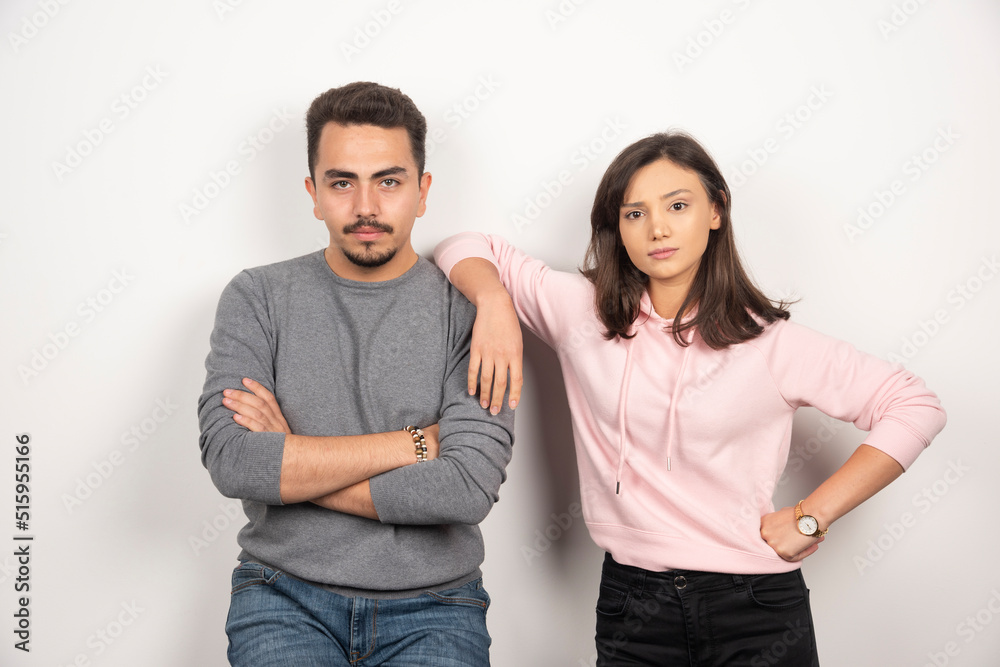 Young couple standing with serious expression Young couple standing with serious expression