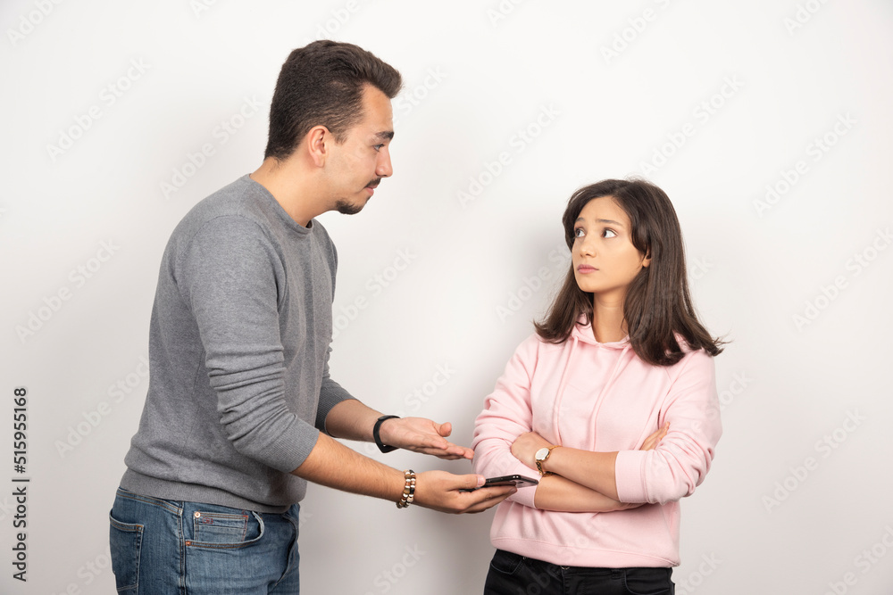 Young man showing his telephone to woman Young man showing his telephone to woman