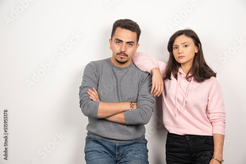 Young couple standing with serious expression