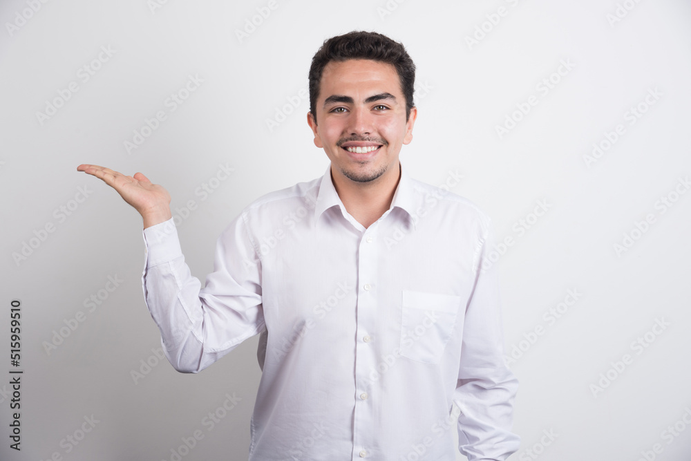 Young businessman holding open space on white background Young businessman holding open space on white background