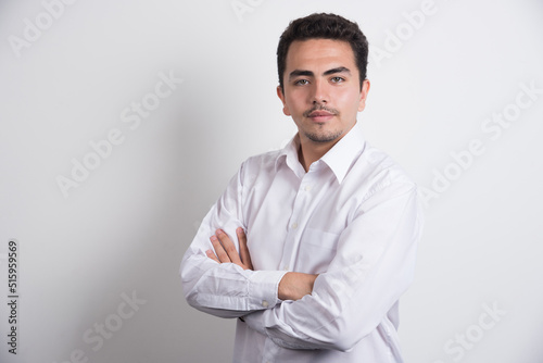 Young businessman crossing arms on white background © azerbaijan-stockers