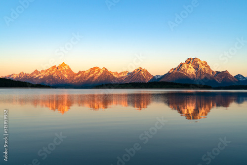 landscape of snow mountain under morning sunlight reflecting in the lake