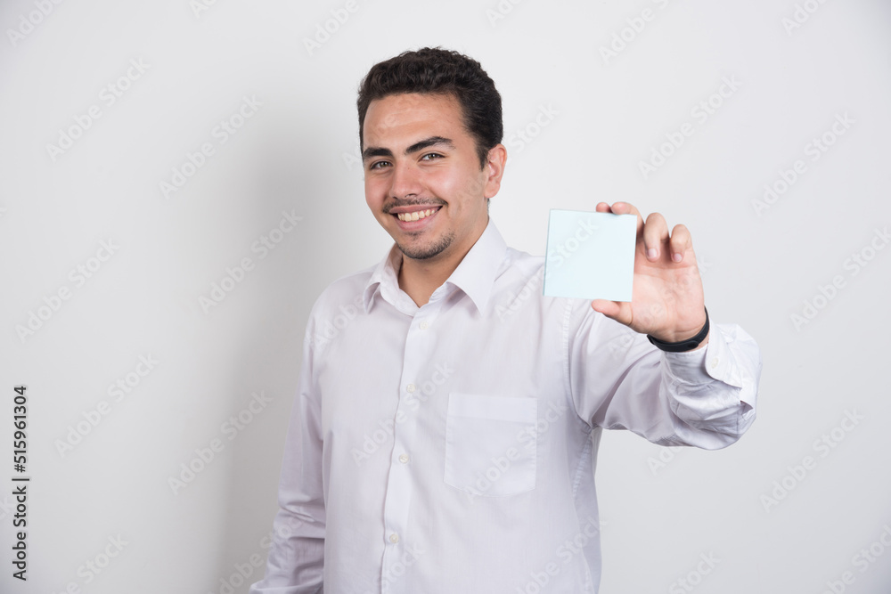 Businessman showing memo pads on white background Businessman showing memo pads on white background
