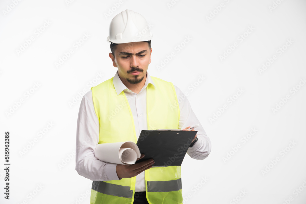 Engineer in uniform checking the tasklist Engineer in uniform checking the tasklist