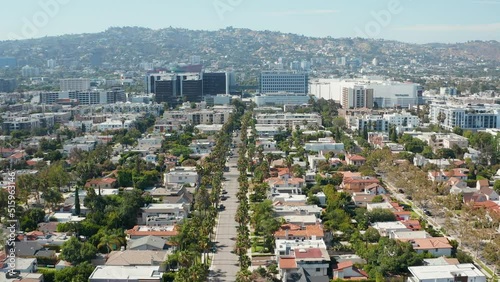 Aerial shot of Beverly Hills, tall palm trees, and commercial buildings of LA