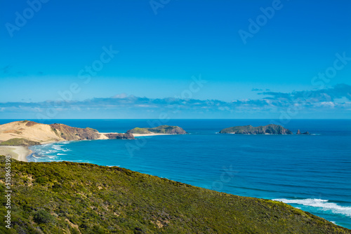 Stunning view over at Te Werahi Beach and Cape Maria Van Diemen. Vivid blue sea of the Tasman Sea and clear sky of a bright winter day. Cape Reinga, North Island, New Zealand