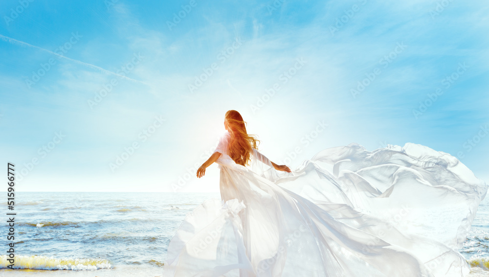 Model in White Dress Flying on Wind. Happy Woman Enjoying Sun looking away at Blue Sky. Carefree Girl dreaming at Sea Beach Resort. Freedom and Spiritual Relax Concept - obrazy, fototapety, plakaty 