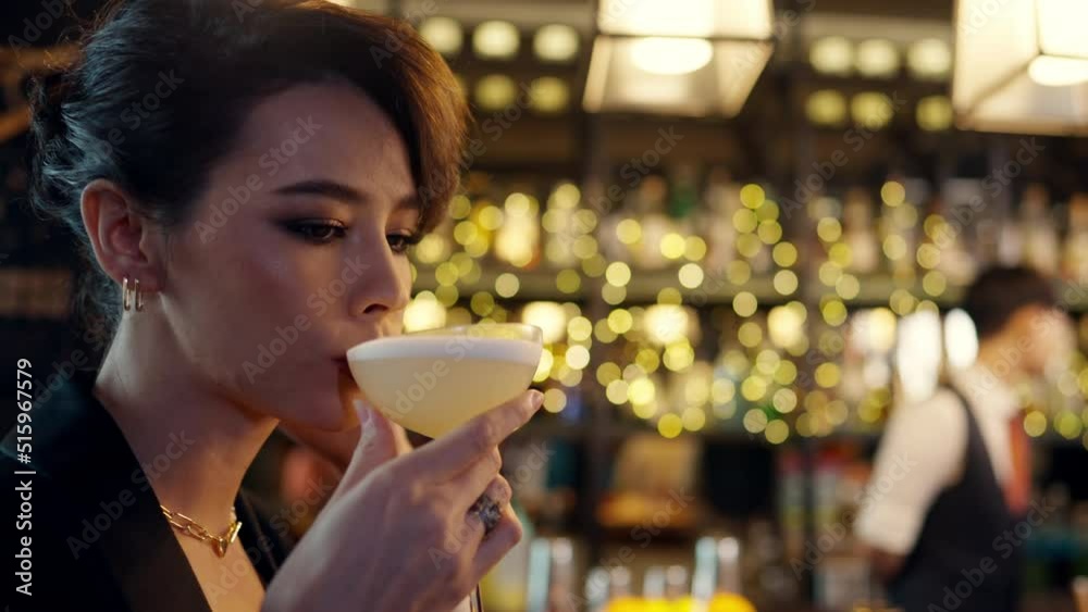 Close up of Attractive Caucasian woman relax and enjoy hangout nightlife and drinking fancy cocktail at luxury restaurant bar. Beautiful female celebrating holiday event party at nightclub in the city Close up of Attractive Caucasian woman relax and enjoy hangout nightlife and drinking fancy cocktail at luxury restaurant bar. Beautiful female celebrating holiday event party at nightclub in the city