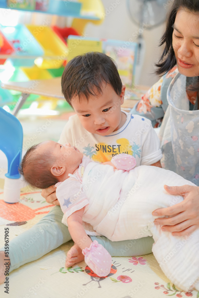 Obraz premium Big Brother Looking at his Newborn Baby, Sibling relationship