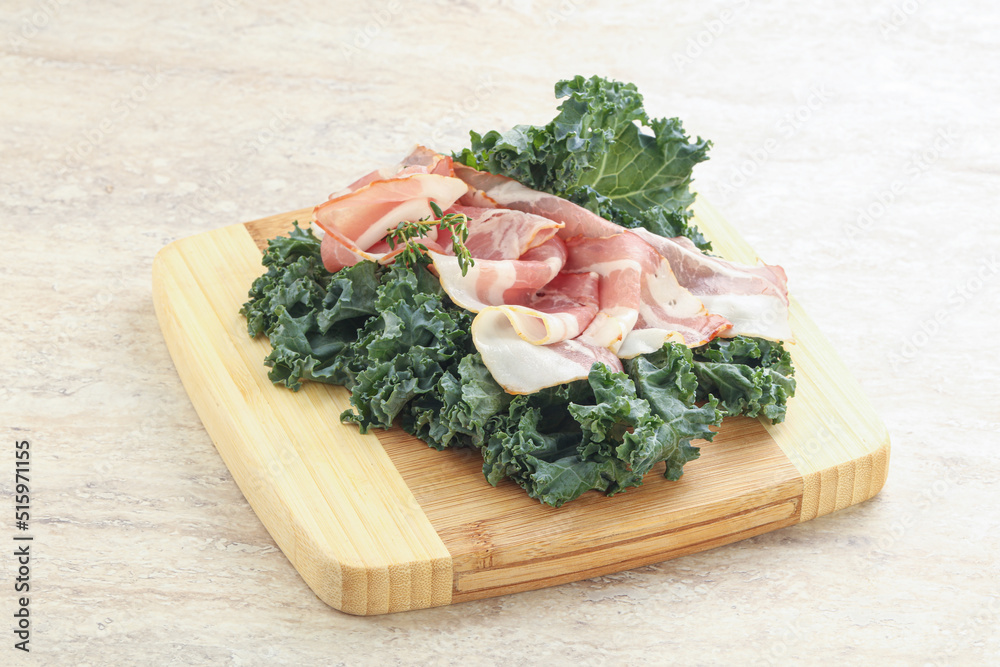 Raw pork bacon over board