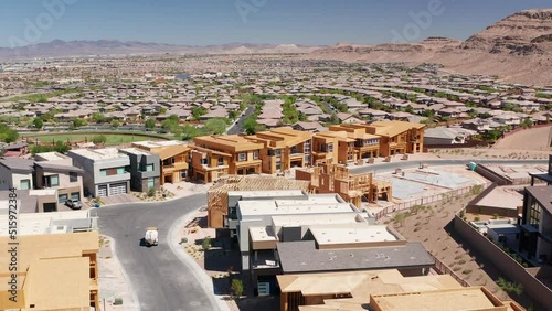 Aerial view of luxury condo construction in affluent residential community 