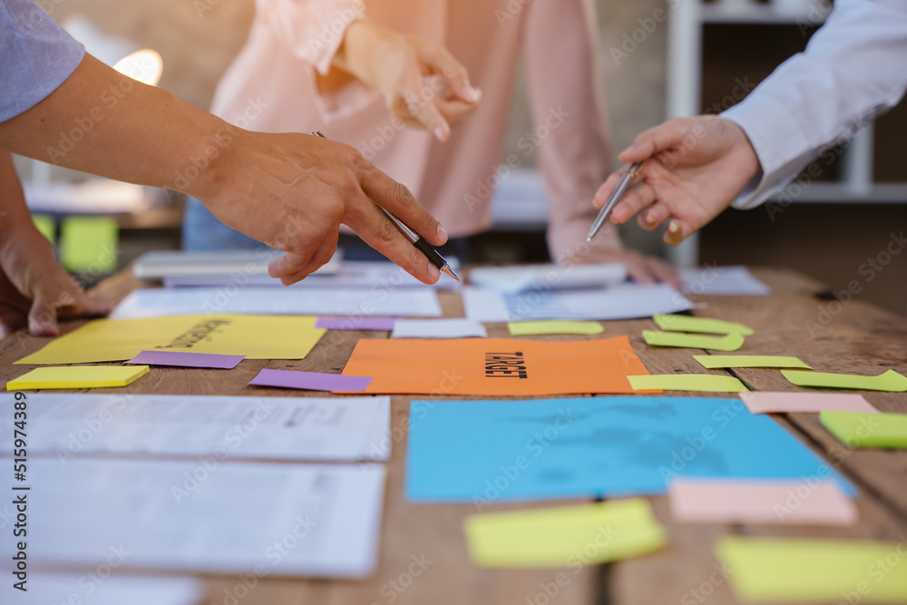 Close up of hands working and brainstorming on paperworks about business financial and marketing.
