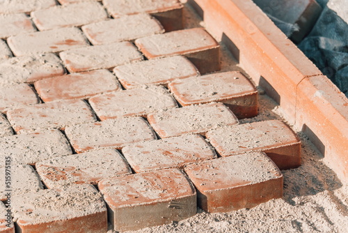 Brown concrete permeable flooring assembled on a substrate of sand. Abstract photo of bricks in the sunlight photo