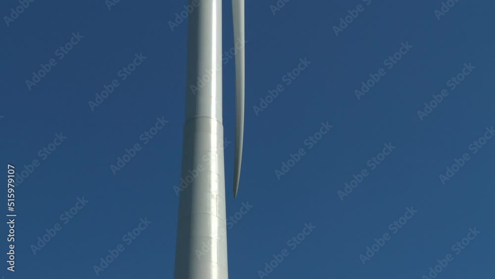 wind turbine close up bending blade slow rotate blue sky backdrop wind turbine close up bending blade slow rotate blue sky backdrop