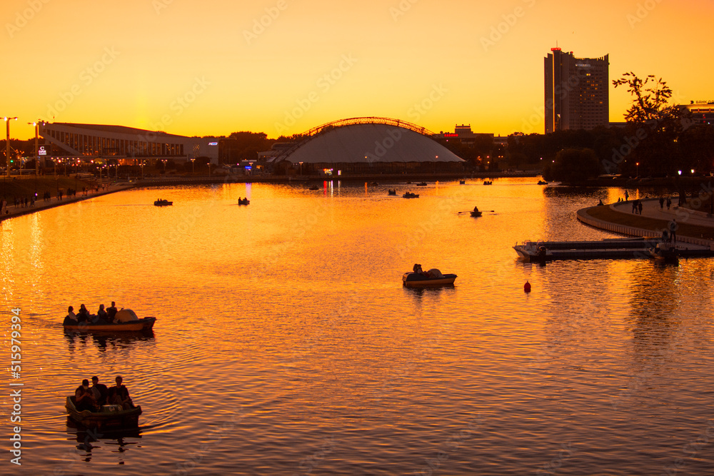 Naklejka premium Minsk, Belarus - JUNE 23, 2022 : Vacationers on the Svisloch river in the center of Minsk . Traetskae Pradmestse or Trinity Suburb e historical center of Minsk.