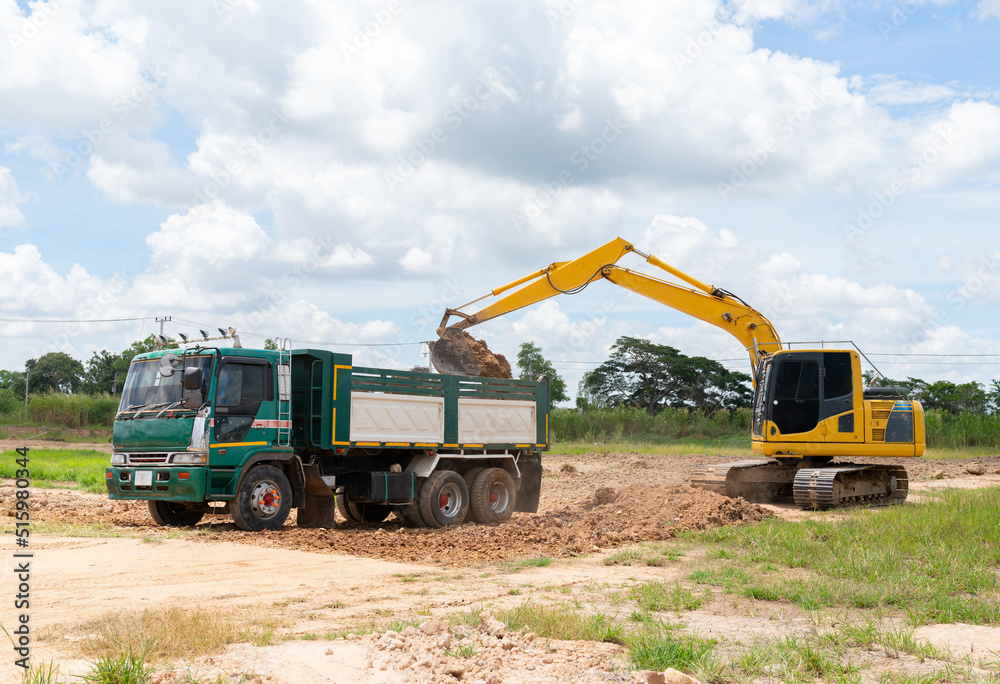 Excavator adjust surface soil and loading to truck. Excavator adjust surface soil and loading to truck.