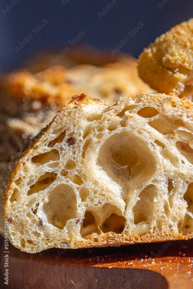 Bread macro. Bread pores. Fresh baguette with grains macro.Bakery advertisement. Seeds in bread. Freshly baked bread. French baguette cut. Fresh bakery. Bun in a cut. Baking from the oven.Bakery Bread macro. Bread pores. Fresh baguette with grains macro.Bakery advertisement. Seeds in bread. Freshly baked bread. French baguette cut. Fresh bakery. Bun in a cut. Baking from the oven.Bakery