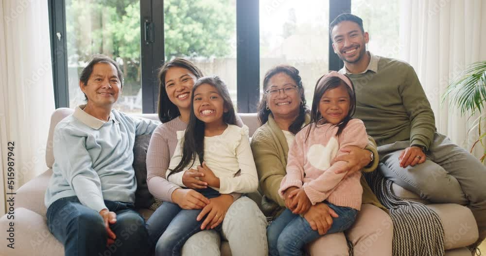 Portrait of happy and cheerful family bonding over the weekend on couch together. Loving grandparents visiting their children and little grandchildren at home. Girls bonding with grandma and grandpa Portrait of happy and cheerful family bonding over the weekend on couch together. Loving grandparents visiting their children and little grandchildren at home. Girls bonding with grandma and grandpa