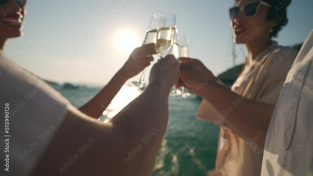 Caucasian man and woman enjoy luxury outdoor lifestyle celebrating holiday party and toasting champagne glass together while catamaran yacht boat sailing in the sea at summer sunset on travel vacation
