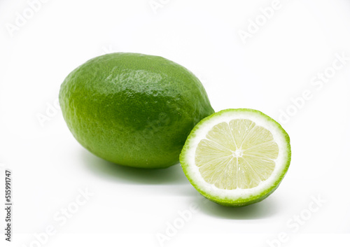 whole and slice green Lemons isolated on white background.