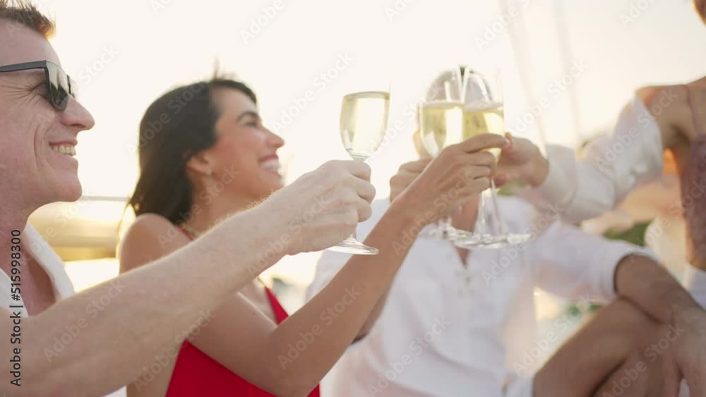 Caucasian man and woman enjoy luxury outdoor lifestyle celebrating holiday party and toasting champagne glass together while catamaran yacht boat sailing in the sea at summer sunset on travel vacation
