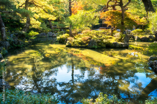 Beautiful golden light and autumn colours with reflections in the pond at the Silver Pavillion or Ginkaku-Ji Zen Temple and gardens, one of the 'must see' destinations in Kyoto, Japan.